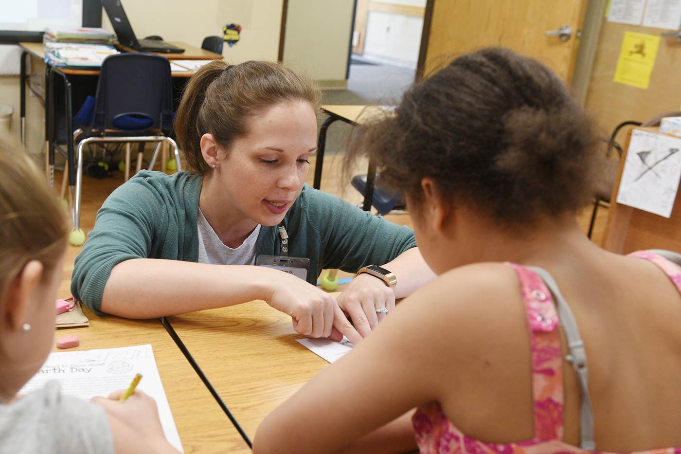 Natchaug teacher works with two students while they learn about earth day