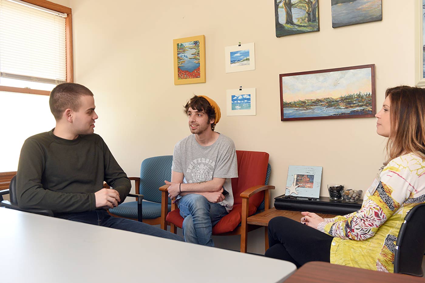 Two teen Natchaug students talk to school administrator during enrollment process