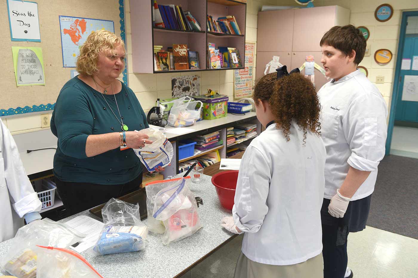 Natchaug school teacher works one on one with two students